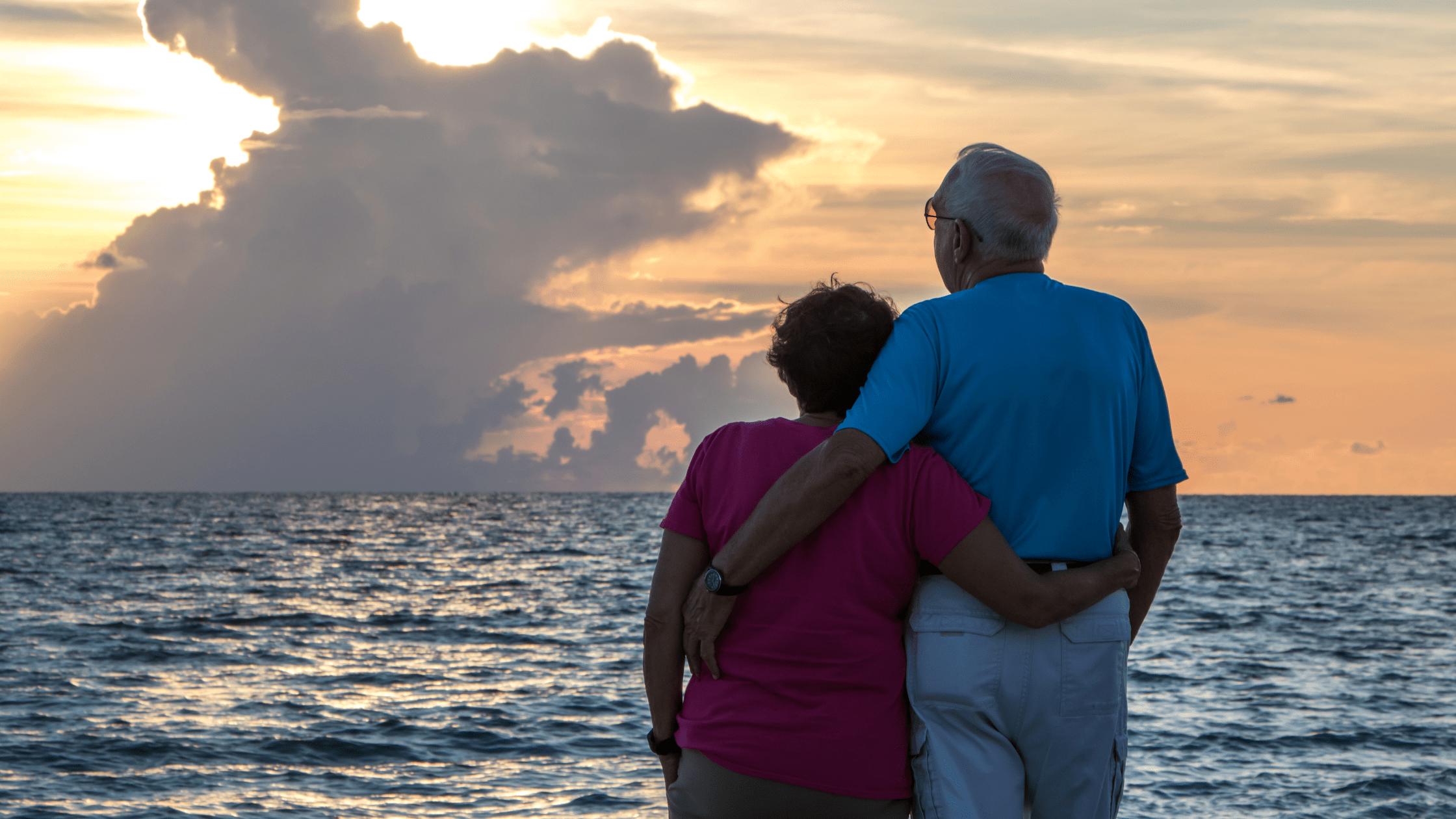 A happy older couple enjoying the sunset not worrying about their retirement income because they have guaranteed income for life with their annuities with Infinite Retirement Solutions